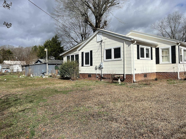 view of side of home with a lawn