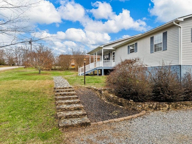 exterior space featuring a porch and a yard