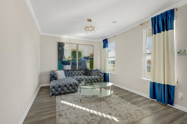 living room featuring a chandelier, ornamental molding, and dark wood-type flooring