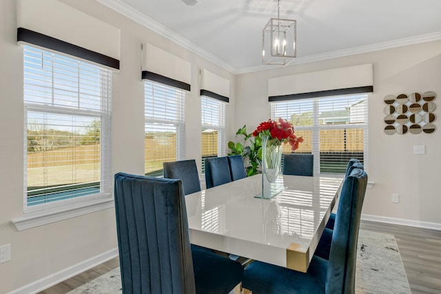 dining area featuring hardwood / wood-style floors, a notable chandelier, and ornamental molding