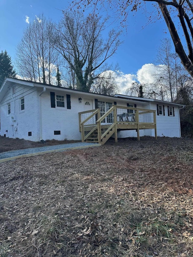 rear view of house featuring a deck