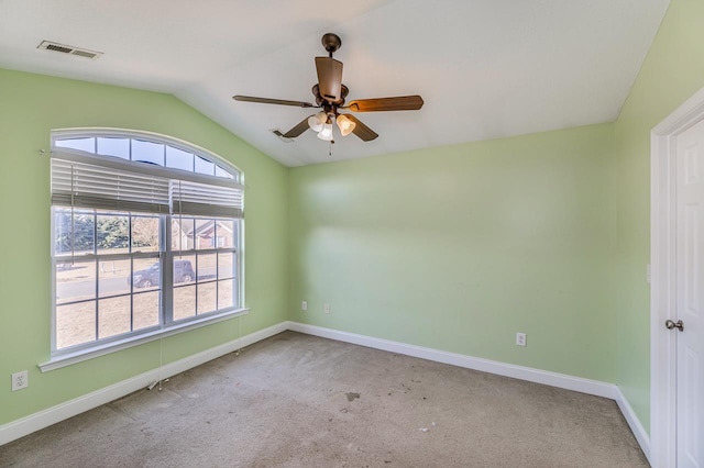 empty room featuring light carpet, ceiling fan, and lofted ceiling