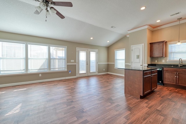 kitchen with sink, dark hardwood / wood-style flooring, lofted ceiling, and hanging light fixtures