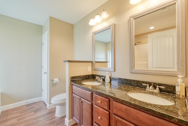 bathroom featuring hardwood / wood-style floors, vanity, and toilet