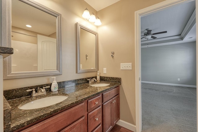 bathroom with vanity, ceiling fan, and crown molding