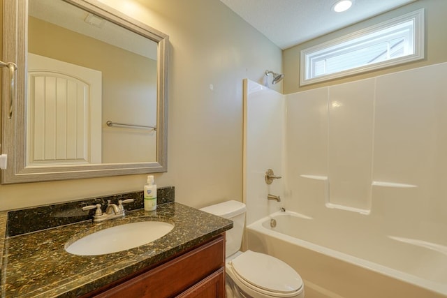 full bathroom featuring vanity, shower / bathtub combination, toilet, and a textured ceiling