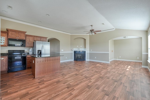 kitchen with dark hardwood / wood-style flooring, ceiling fan, crown molding, black appliances, and a kitchen island