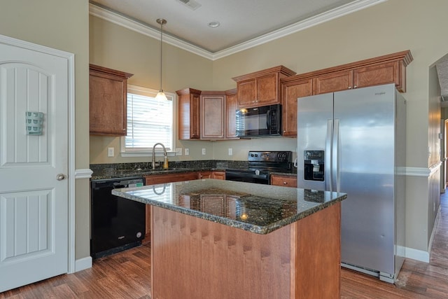 kitchen featuring dark hardwood / wood-style flooring, decorative light fixtures, a kitchen island, black appliances, and ornamental molding