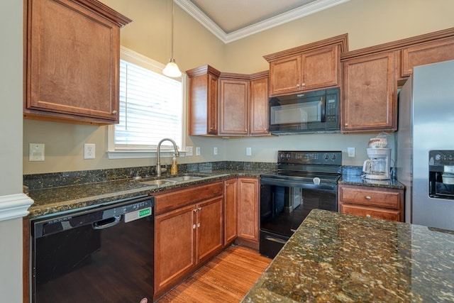 kitchen with black appliances, crown molding, sink, hanging light fixtures, and dark stone countertops