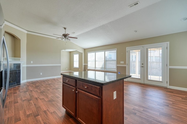 kitchen featuring a center island, lofted ceiling, dark wood-type flooring, french doors, and ceiling fan