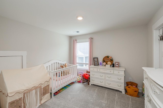 bedroom with carpet and a crib