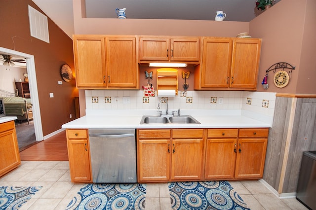 kitchen with stainless steel dishwasher, ceiling fan, light tile patterned floors, and sink