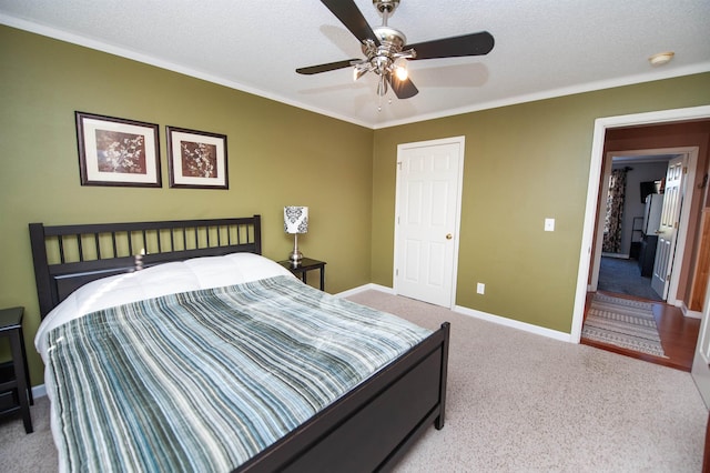 carpeted bedroom featuring a textured ceiling, ceiling fan, and crown molding