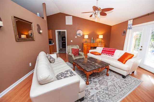 living room with ceiling fan, light hardwood / wood-style flooring, and lofted ceiling