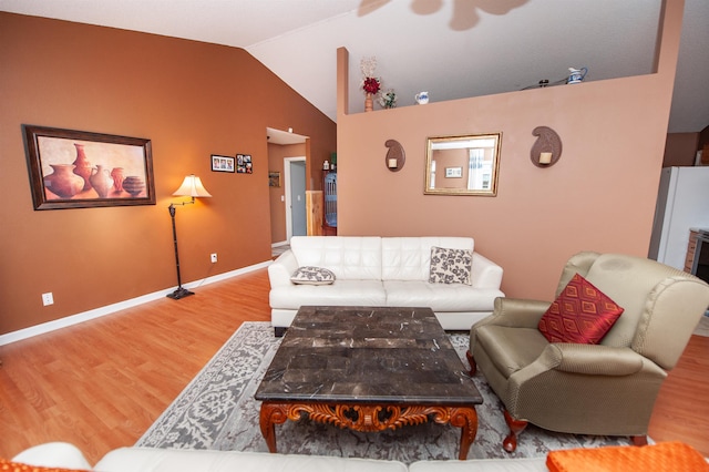 living room with hardwood / wood-style flooring and vaulted ceiling