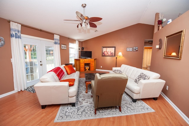 living room with ceiling fan, lofted ceiling, light wood-type flooring, and french doors