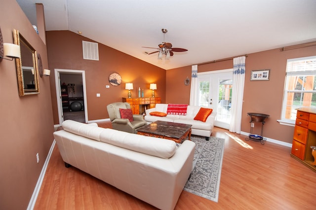 living room featuring french doors, vaulted ceiling, light hardwood / wood-style flooring, and ceiling fan