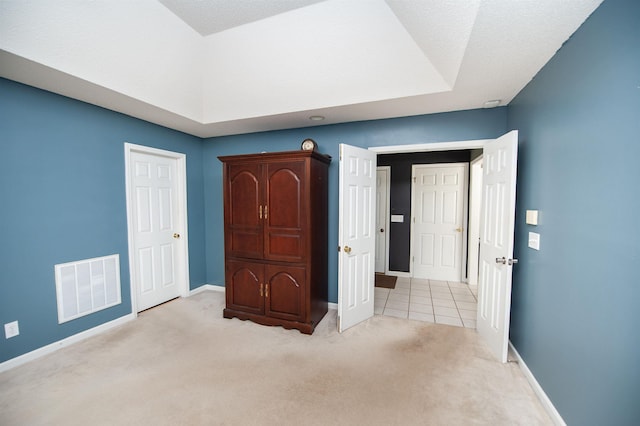 unfurnished bedroom featuring light carpet