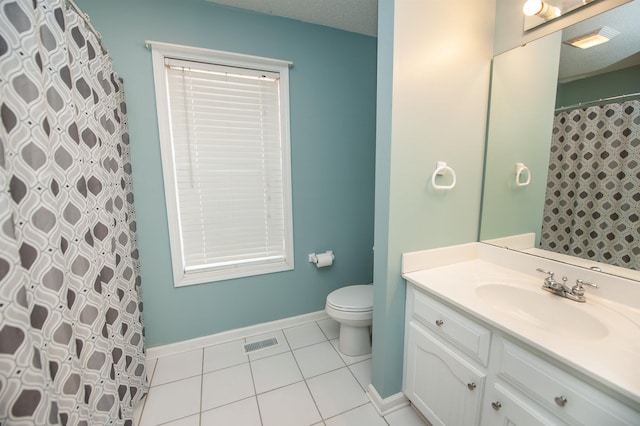 bathroom with walk in shower, tile patterned floors, a textured ceiling, toilet, and vanity