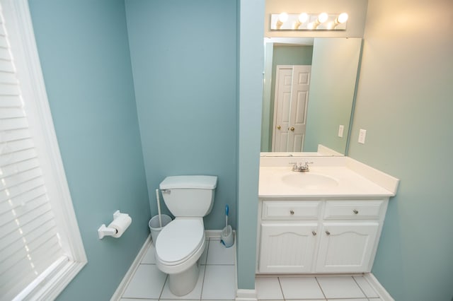 bathroom featuring tile patterned flooring, vanity, and toilet