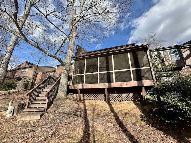 back of property with a sunroom