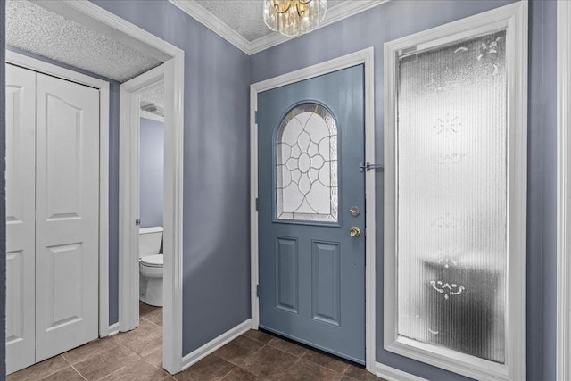 tiled entrance foyer featuring ornamental molding