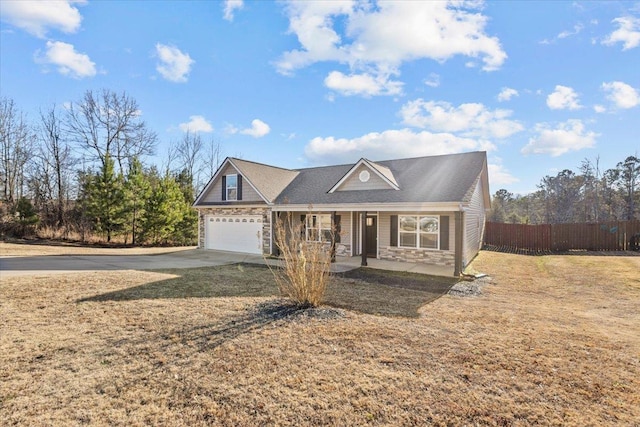 view of front of house with a garage, a porch, and a front yard