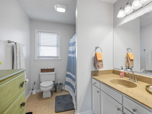 bathroom featuring tile patterned floors, vanity, and toilet