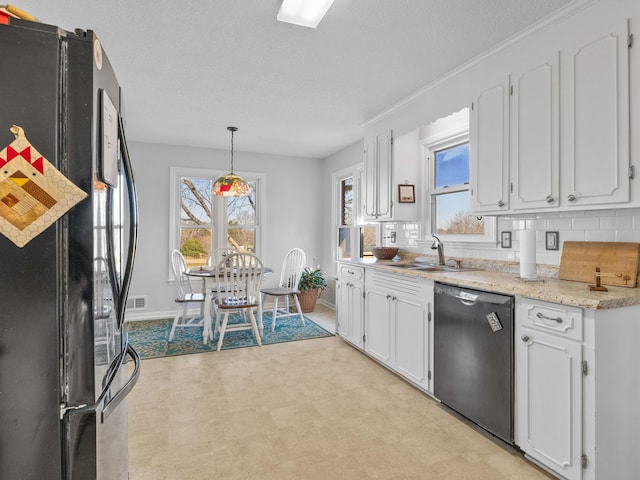 kitchen with black appliances, pendant lighting, white cabinets, and sink