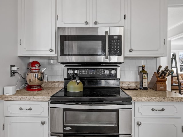 kitchen with stainless steel appliances and white cabinetry