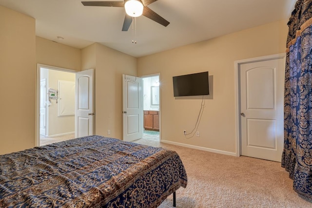 carpeted bedroom featuring ensuite bath and ceiling fan