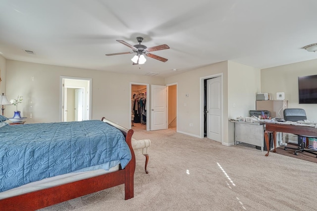 carpeted bedroom featuring ceiling fan, a spacious closet, and a closet