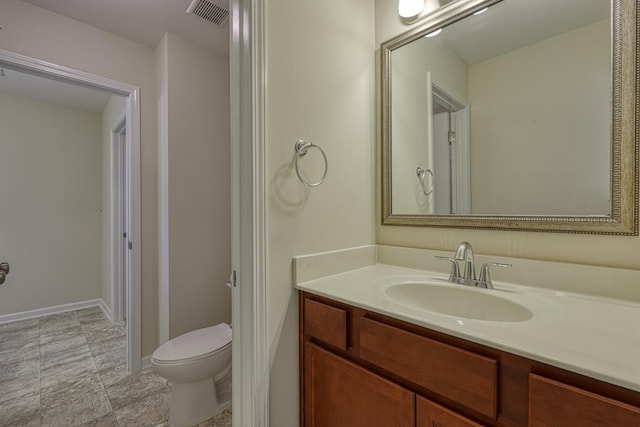 bathroom featuring vanity and toilet