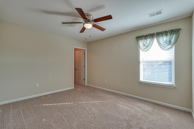 carpeted empty room featuring ceiling fan