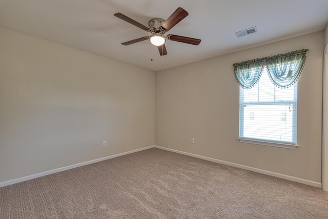 carpeted empty room featuring ceiling fan