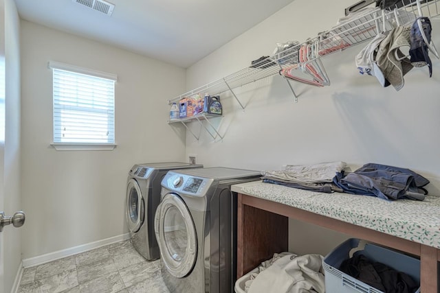 clothes washing area with washer and clothes dryer