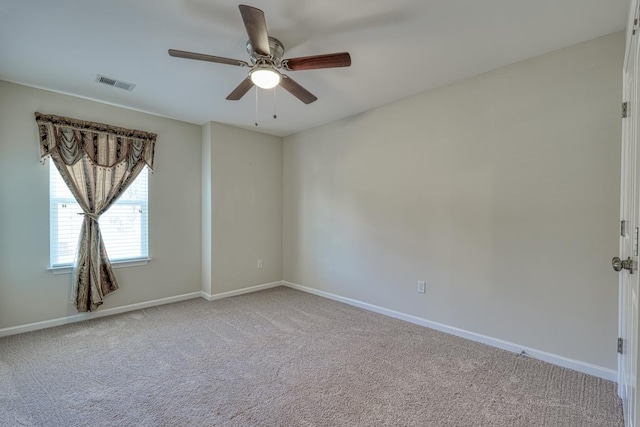 carpeted empty room featuring ceiling fan