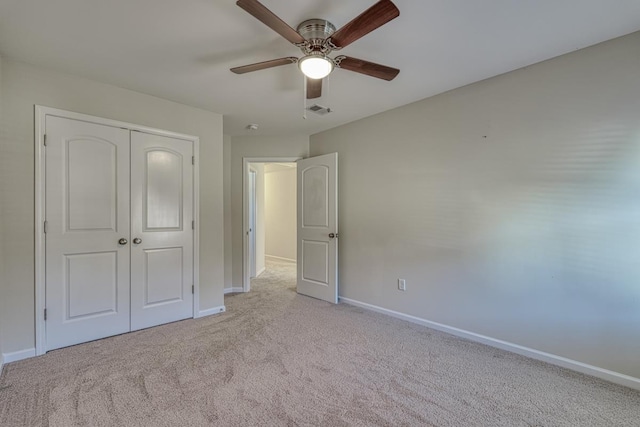 unfurnished bedroom with a closet, ceiling fan, and light colored carpet