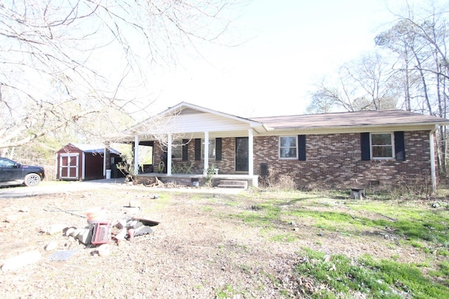 view of front of home featuring a porch and a storage shed