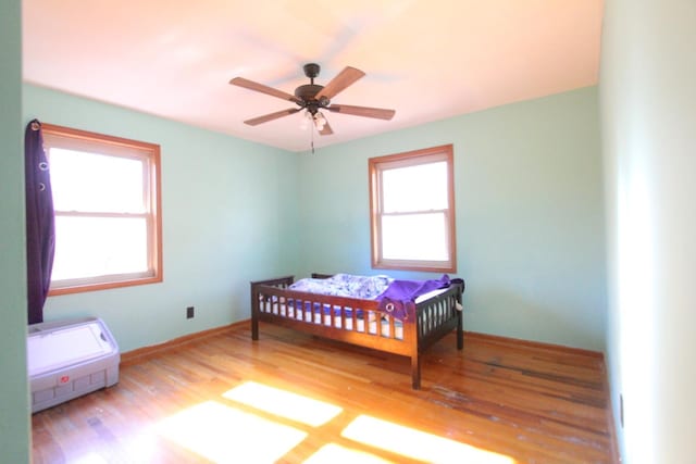 bedroom featuring light hardwood / wood-style floors and ceiling fan