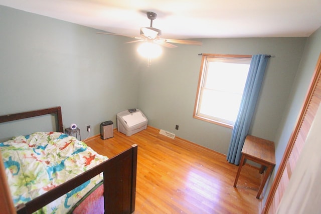 bedroom with hardwood / wood-style flooring and ceiling fan