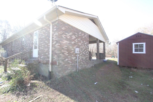 view of side of home with a storage unit