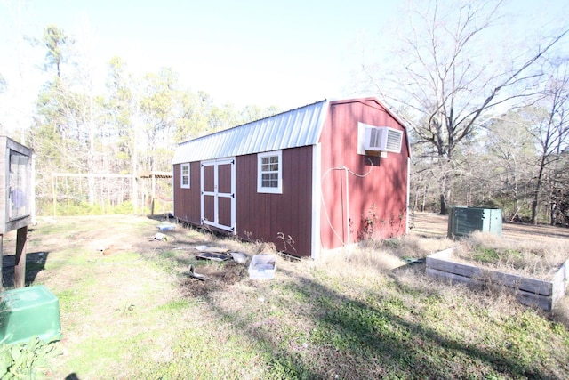 view of outbuilding with a wall unit AC