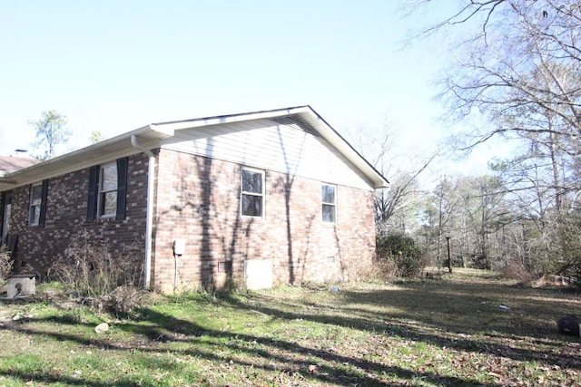 view of side of home featuring a lawn