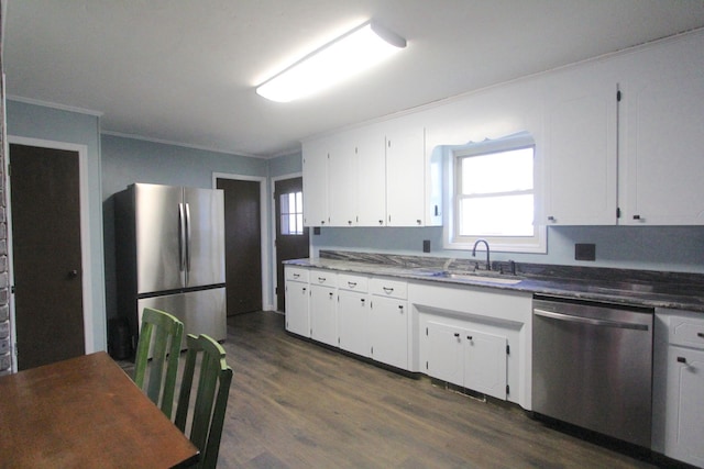 kitchen with crown molding, white cabinetry, sink, and stainless steel appliances