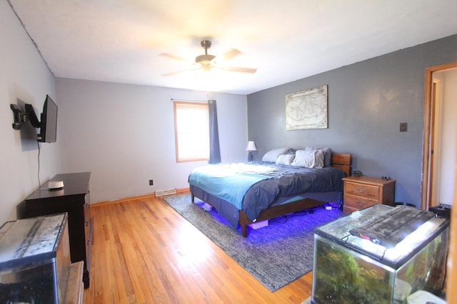 bedroom with wood-type flooring and ceiling fan