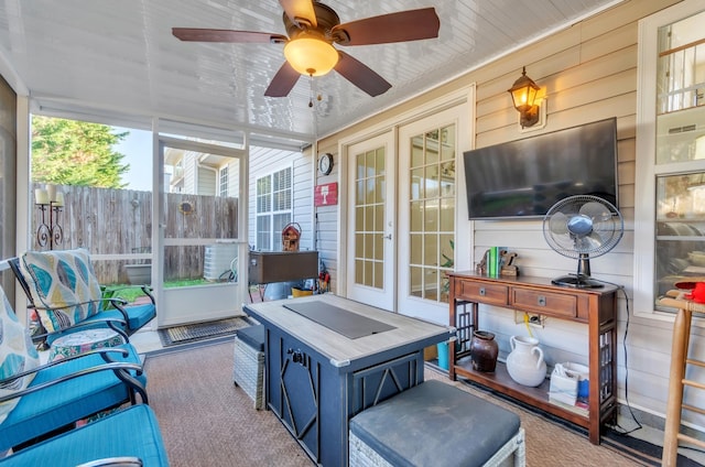 sunroom featuring ceiling fan