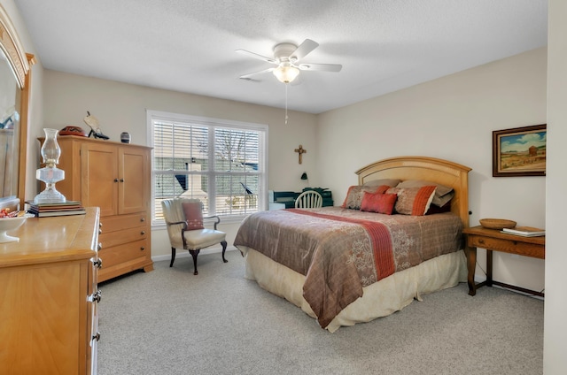 bedroom featuring ceiling fan and light carpet