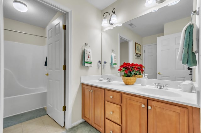 bathroom featuring tile patterned flooring and vanity