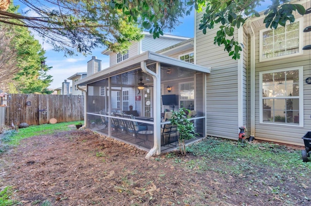 rear view of property featuring a sunroom